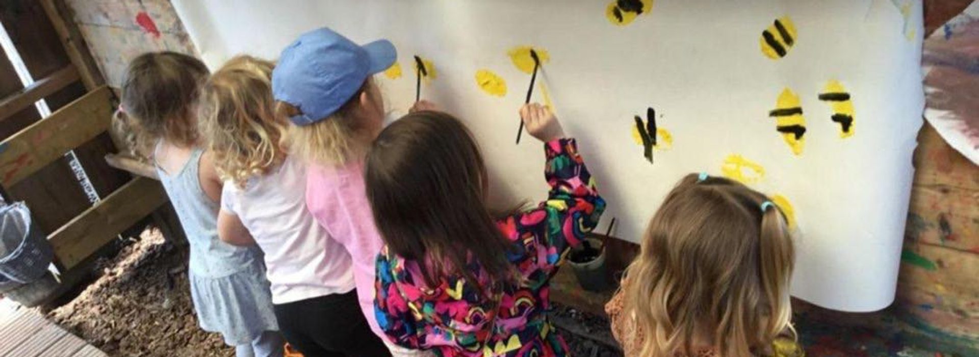 children printing bees with potatoes and paint