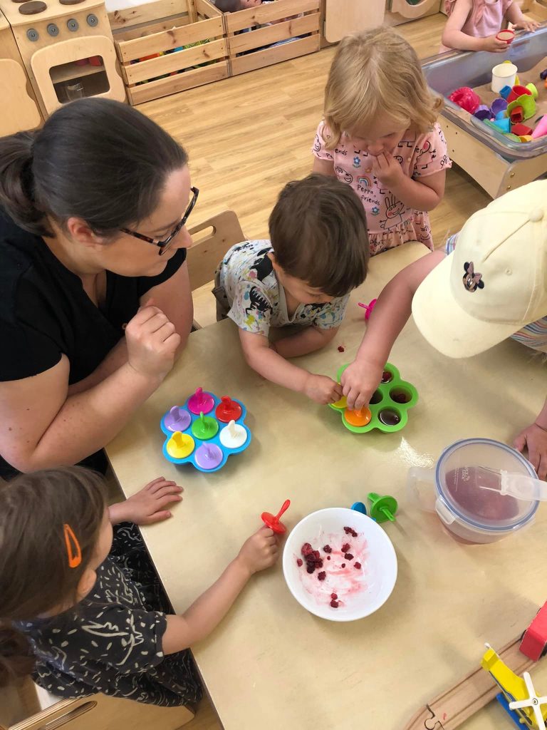 Nursery manager working with child