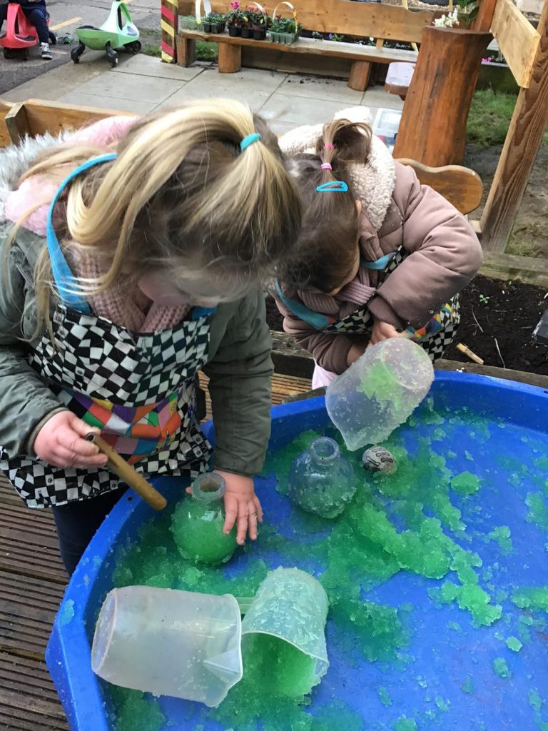 messy exploration of gel using jugs