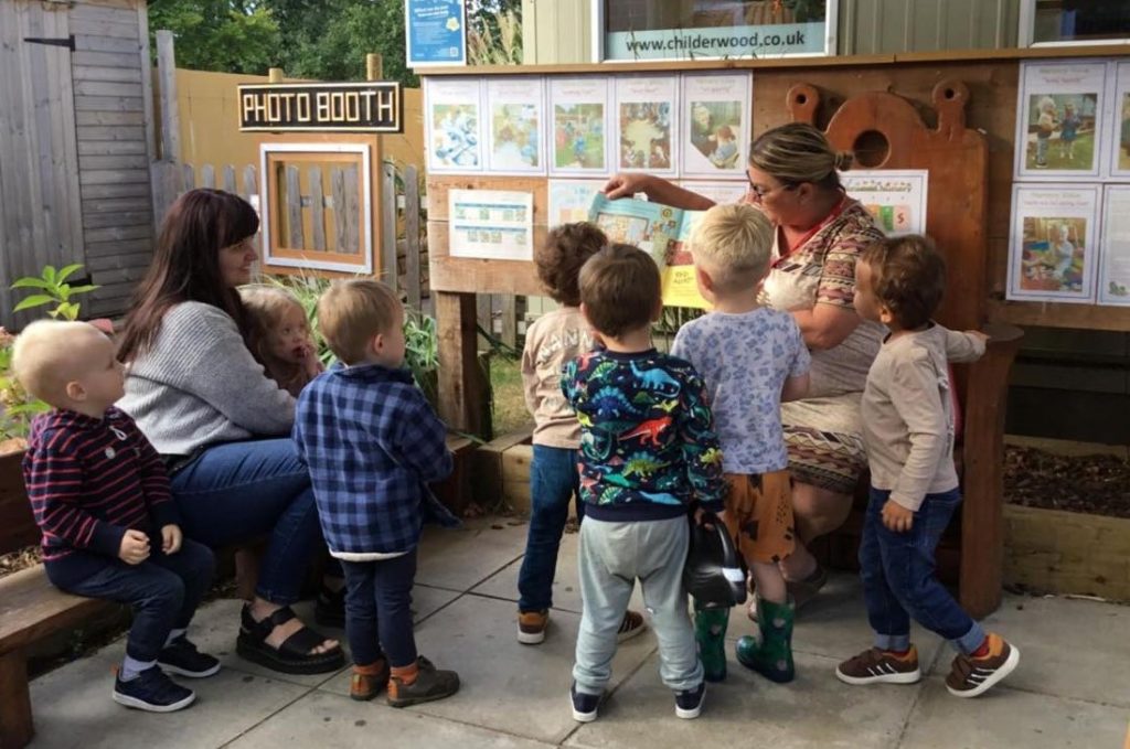 Parents reading to children at nursery